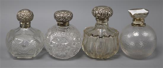 Four silver mounted spherical glass scent bottles, largest 12cm.